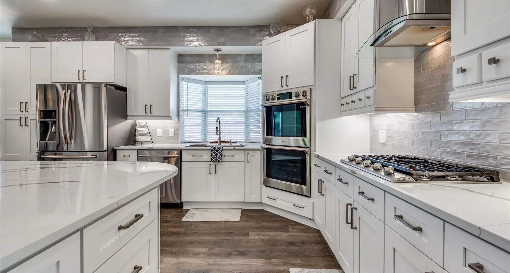 Premium white kitchen remodel with quartz countertops and stainless appliances